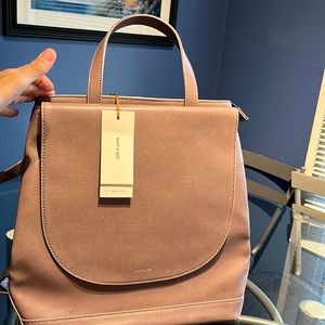 Brand new with tags Matt&Nat convertible handbag/ backpack. Light pink in color.